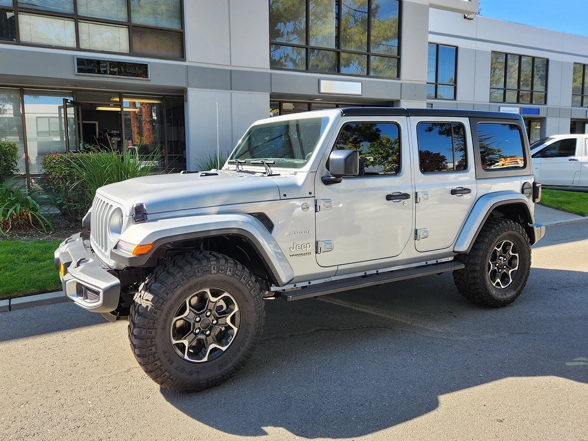 Fleet vehicle with tinted windows outside a commercial building
